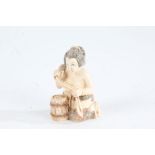 Japanese Meiji period carved ivory netsuke, in the form of a kneeling woman, with coloured