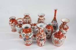 Collection of Japanese Kutani porcelain vases, all painted in iron red and gilt with figures,