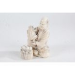 Japanese Meiji period carved ivory okimono, of a seated figure with two toads, with penwork
