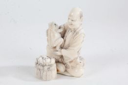 Japanese Meiji period carved ivory okimono, of a seated figure with two toads, with penwork