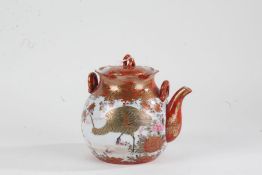 Japanese Kutani teapot, 20th century, having lift up lid, shaped rim and painted in iron red and