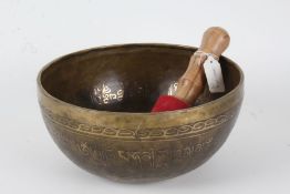 Eastern bronze singing bowl, the interior with script and buddha, the exterior also with script,