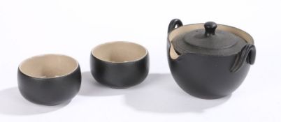 Contemporary Japanese tea set, with a black glazed pot and two bowls each with an impressed seal