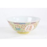 Chinese porcelain bowl, marks for Qianlong reign but later, having colourful flowers on a yellow