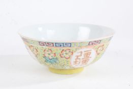 Chinese porcelain bowl, marks for Qianlong reign but later, having colourful flowers on a yellow