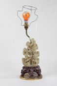 Chinese carved soapstone table lamp, carved with flowers and raised on an oval brass base, 32cm high