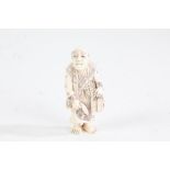 Japanese Meiji period carved ivory netsuke, in the form of a standing gentleman, character mark to