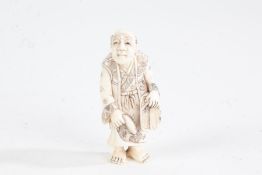 Japanese Meiji period carved ivory netsuke, in the form of a standing gentleman, character mark to