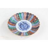 Japanese porcelain imari dish, having frilled rim and painted in blue, red, green and gilt,