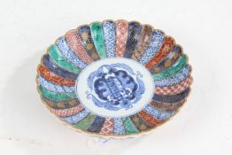 Japanese porcelain imari dish, having frilled rim and painted in blue, red, green and gilt,