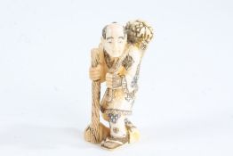 Japanese Meiji period carved ivory netsuke, in the form of a man with a basket of food over his