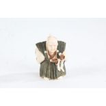 Japanese Meiji period carved ivory netsuke, in the form of a warrior, with green stained garment,