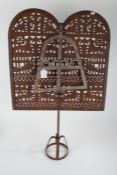 Eastern rustic metal lamp screen, with pierced screen and hanging lamp raised on a circular base,