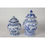 Two Chinese blue and white porcelain vases and covers, with foliate and bird decoration, 27cm and