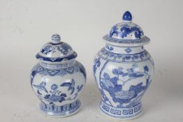 Two Chinese blue and white porcelain vases and covers, with foliate and bird decoration, 27cm and