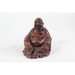 Chinese carved hardwood figure of Buddha, 20th century, with paper label to base, 15.5cm high