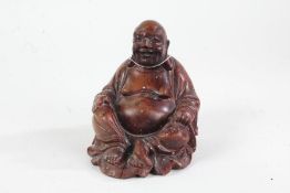 Chinese carved hardwood figure of Buddha, 20th century, with paper label to base, 15.5cm high