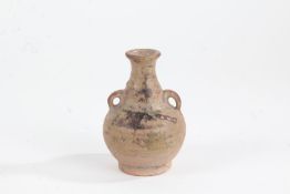 Small pottery baluster vase, probably Chinese, with flared neck, handle either side and baluster