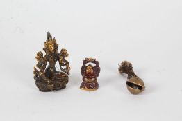 Two 20th century eastern bronzed ornaments, one in the form of  buddha (9cm high), together with a
