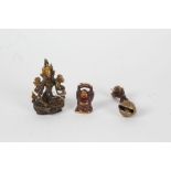 Two 20th century eastern bronzed ornaments, one in the form of  buddha (9cm high), together with a