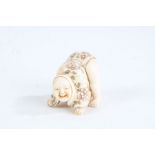 Japanese Meiji period carved ivory netsuke, in the form of a father and son, character mark to base,