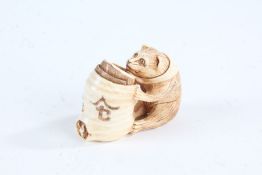 Japanese Meiji period carved ivory netsuke, in the form of a seated cat trying to catch a mouse,