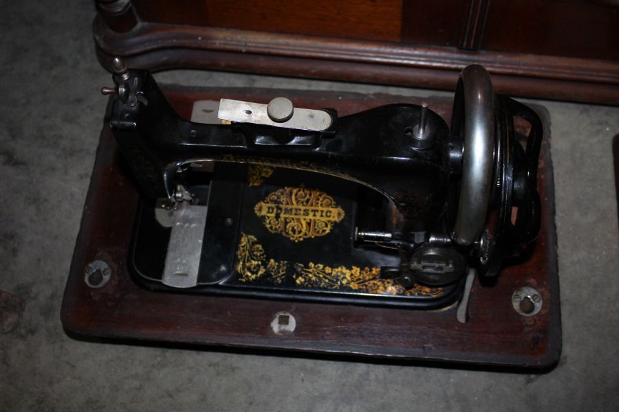 Domestic, circa 1880/1890 sewing machine. Made in the USA. Wooden base damaged and part missing.