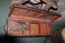 Stained wooden carpenters tool chest, containing a small amount of tools