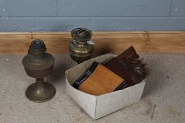 Two brass oil lamps, a crumb scoop with ebonised rim and a mahogany acanthus decorated shelf (4)