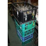 Five crates of various advertising milk bottles (5)
