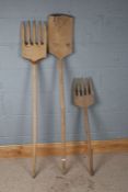 Two homemade carved wooden long handled forks and a shovel (3)