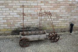 Novelty wooden and wrought iron plant stand, with four iron wheels