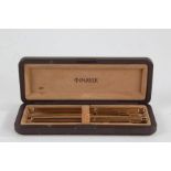 Parker three piece gold plated pen set, comprising of two fountain pens and a ballpoint pen, in