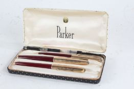 Parker three piece pen set, 12ct rolled gold and maroon case, comprising fountain pen, propelling