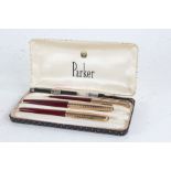 Parker three piece pen set, 12ct rolled gold and maroon case, comprising fountain pen, propelling