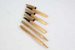 Three Watermans gold plated fountain pens, each with 18ct gold nibs, with a matching propelling