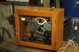 School clock, with a Smiths driven motor, clock and day dials, cased, 45cm wide