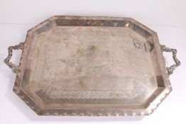 Silver plated tray, with scroll cast handles and canted corners, the central field with scroll