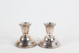 Pair of Elizabeth II silver candlesticks, Birmingham 1962, maker Sanders & Mackenzie, with loaded