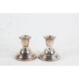 Pair of Elizabeth II silver candlesticks, Birmingham 1962, maker Sanders & Mackenzie, with loaded