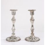 Pair of plated candlesticks, the hexagonal beaded and scroll decorated sconces above waisted