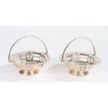Pair of Walker & Hall silver plated bonbon dishes, the swing handles above pierced bodies, 15.5cm