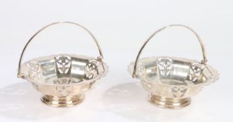 Pair of Walker & Hall silver plated bonbon dishes, the swing handles above pierced bodies, 15.5cm