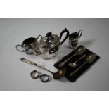 Pair of silver napkin rings, 0.6oz, plated ware to include three piece tea set, cased serving spoons