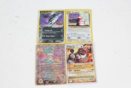 Four Holo Pokemon cards, to include Dark Steelix 10/109, Ancient Mew, Rhyperior DP29, and Porygon2