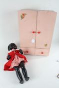 Mid 20th Century Pedigree doll, wearing a red dress, together with a miniature painted wardrobe,