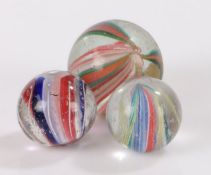 Three 19th Century solid core glass marbles, the largest 20mm (3)