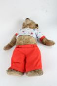 Large stuffed teddy bear, with glass eyes and adjustable arms and legs, 68cm tall