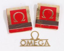 Omega gilt metal clip with rotating bar to the reverse, two Omega match books, one with one match