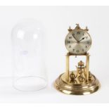 German anniversary clock, the silvered dial with Arabic numerals above four rotating orb weights,